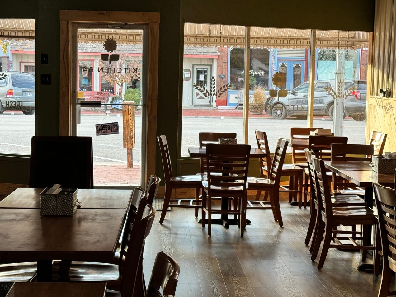 Kitchen 64's dining room, with tables set by the front windows looking onto Washington Street in downtown Marquette