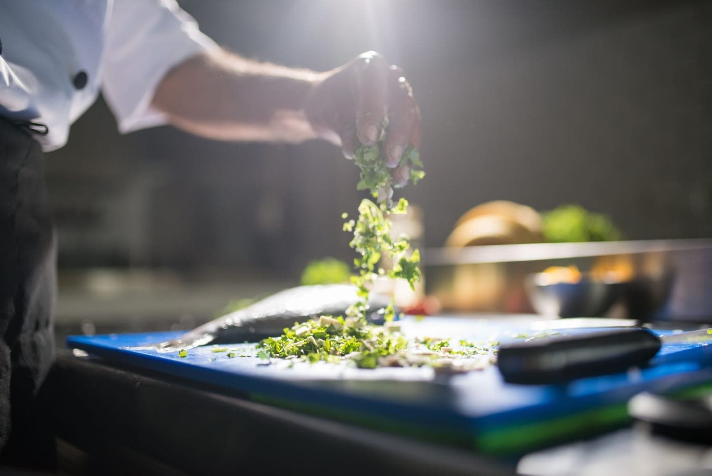 Fresh vegetables being prepared by hand on a cutting board