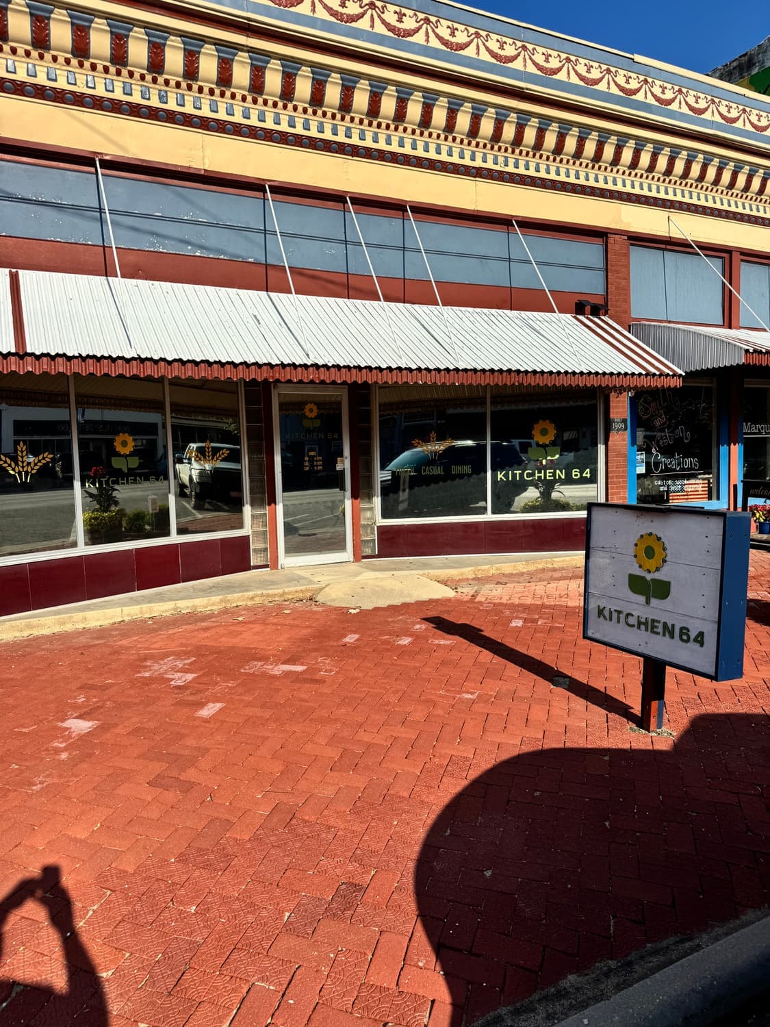 The Kitchen 64 storefront and sidewalk sign on Washington Street in downtown Marquette
