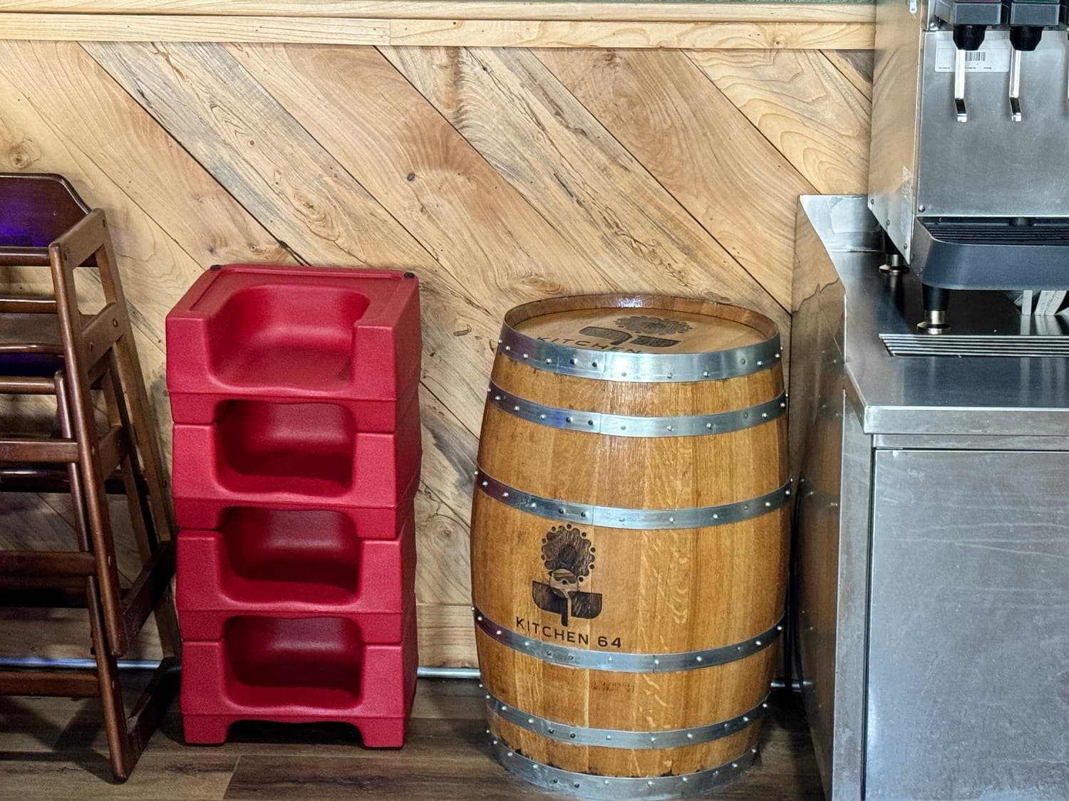 A wooden barrel branded with the Kitchen 64 name in the dining room
